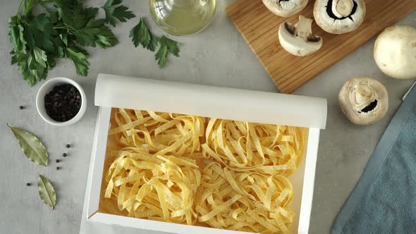 Hands Open Box with Raw Fresh Pasta Picks Up and Check Quality