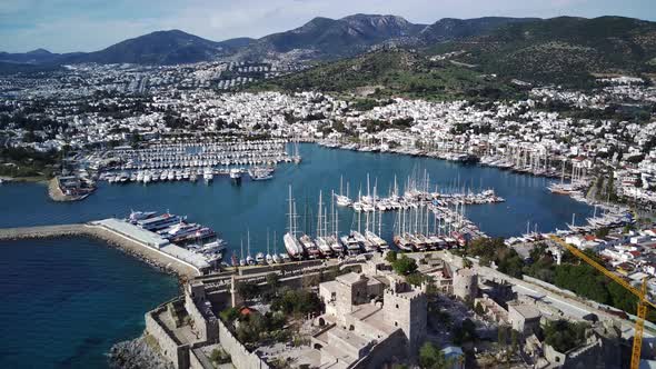 Amazing panoramic view from drone of full of yachts Bodrum harbour and ancient Kalesi castle. alt