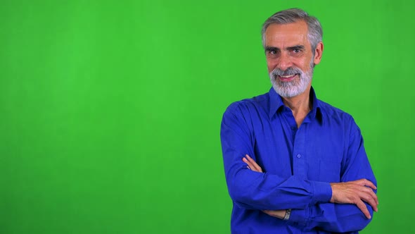 Old Senior Man Smiles To Camera with Folded Arms - Green Screen - Studio alt