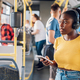 African american woman using smartphone while riding a bus - PhotoDune Item for Sale
