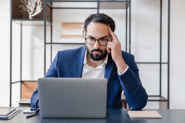 Making a mistake.Tired concentrated hard-working businessman dealing with job problems