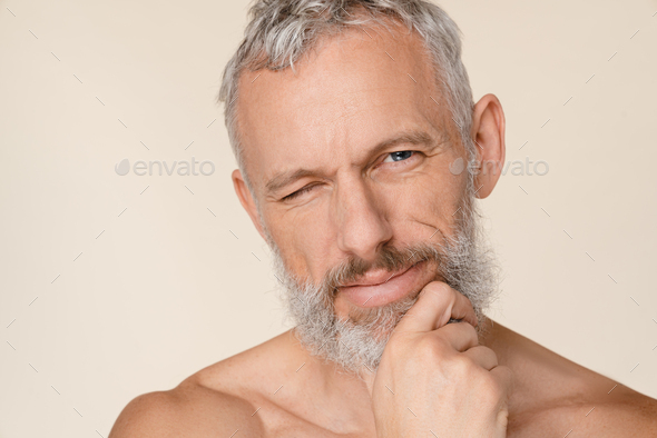 Closeup Caucasian Mature Middle Aged Naked Shirtless Man With Bare Shoulders Winking With An Eye