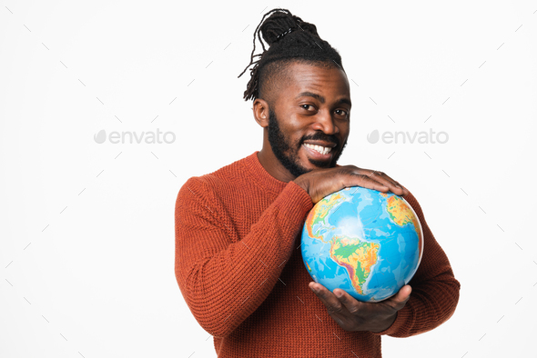 Happy cheerful african-american young man traveler hugging holding embracing Earth globe