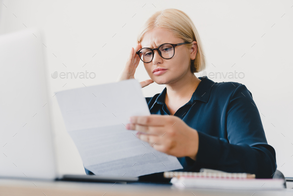 Sad depressed caucasian businesswoman ceo boss student freelancer receiving bill, having debt loan