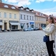 Woman tourist tourist taking photo in an old european city, in front of historical building - PhotoDune Item for Sale
