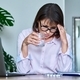 Tired middle-aged woman suffering from headache at workplace with laptop - PhotoDune Item for Sale