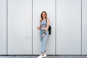 Beautiful casual young woman walking in the street