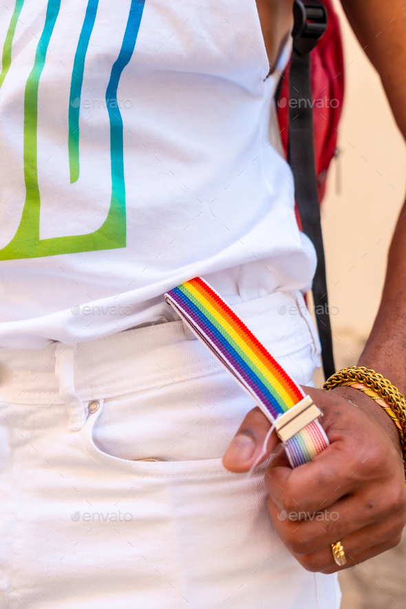 Rainbow suspenders with the hand of a gay black ethnicity man at the