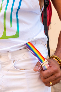 Rainbow suspenders with the hand of a gay black ethnicity man at the pride party, LGBT flag