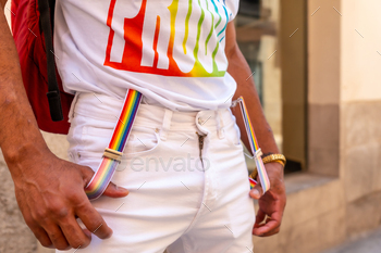 Detail of the rainbow suspenders of a gay black man at the pride party, LGBT flag