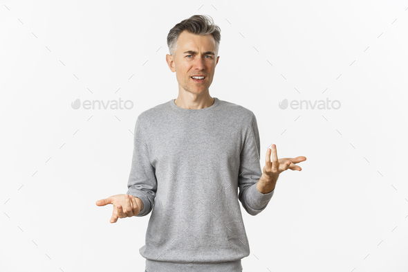 Portrait of confused and disappointed middle-aged man arguing, cant understand something and asking