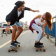 Portrait of happy couple riding skateboards and having fun outdoors. Teenager happiness concept - PhotoDune Item for Sale