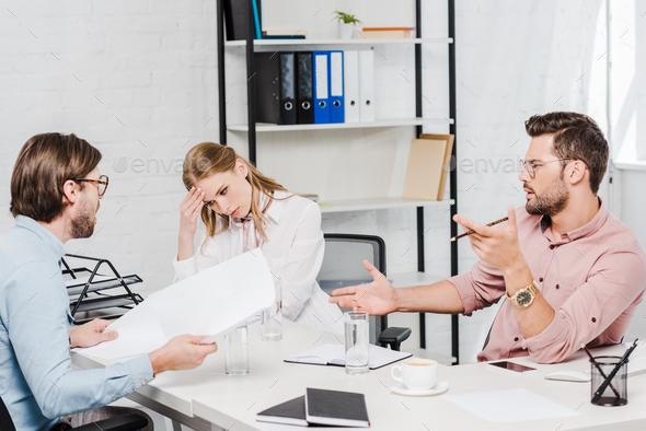 team of confident business partners having conversation at conference room of modern office
