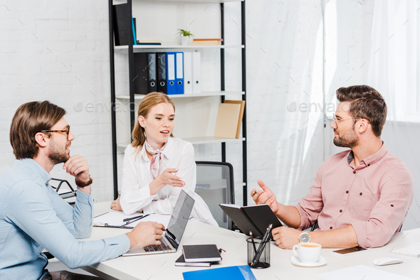 team of successful business partners having conversation at conference room of modern office