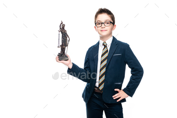 schoolboy in costume of lawyer posing with themis statue isolated on white