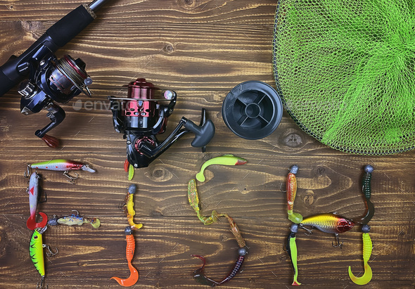 Fishing tackle. Float, wobbler, bait hooks, on a wooden background.  Selective focus Stock Photo by solovei23