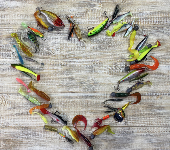 Fishing tackle. Float, wobbler, bait hooks, on a wooden background.  Selective focus Stock Photo by solovei23