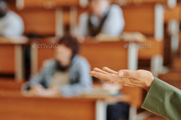 Hand of college teacher standing in front of audience and making speech