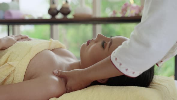 Woman lying in bed for Thai Traditional Massage