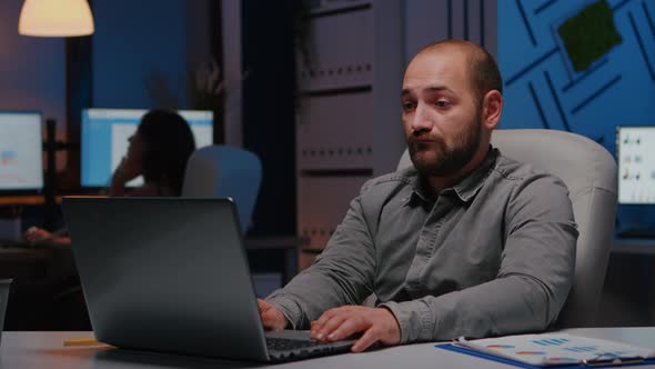 Happy Cheerful Businessman Working in Startup Company Office Late at Night alt
