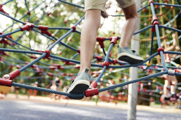 Part of boy's legs climbing at playground - Stock Photo - Images