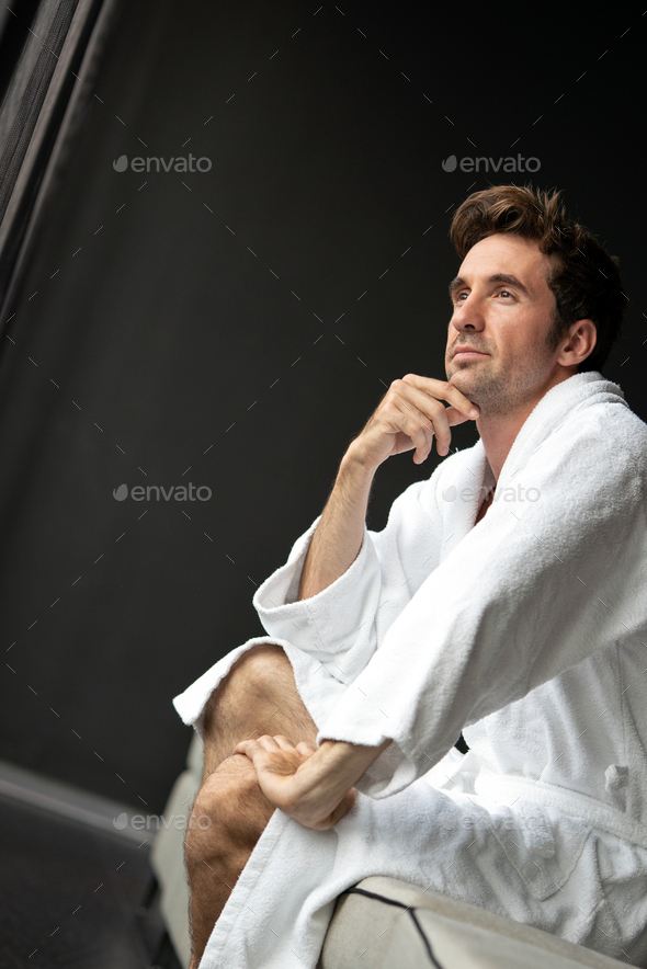 Handsome man in bathrobe relaxing at spa wellness hotel