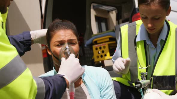 Patient receiving oxygen mask from ambulance team alt