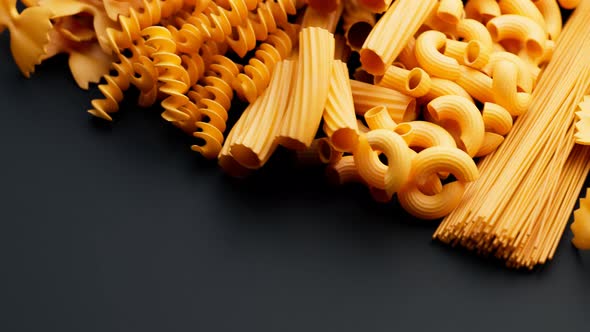 Pile of arranged raw different kinds of pasta. Seamlessly looping animation. alt