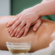 Massaging with massage oil, hands of a female massage therapist massaging a female client - PhotoDune Item for Sale