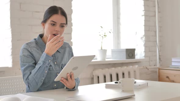 Young Girl Surprised by Results while Using Tablet alt