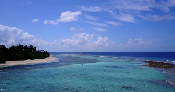 Wide angle overhead clean view of a sunshine white sandy paradise beach and aqua blue water backgrou alt
