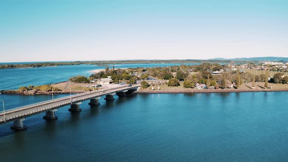 Aerial Flying Over Looking Directly Down On Road Outside Town. Daytime