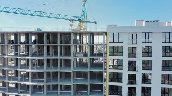 Aerial view of high residential apartment building under construction. alt