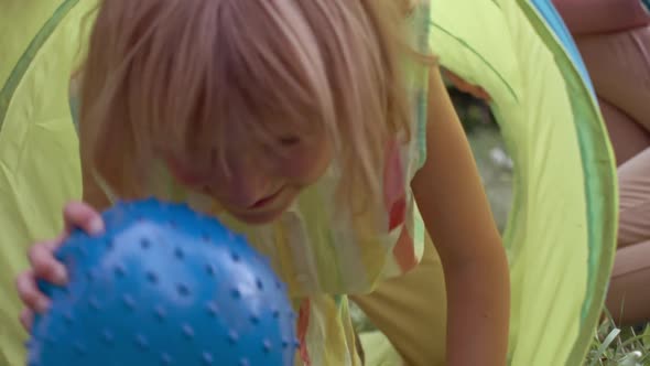 Girl Crawling through Play Tunnel alt