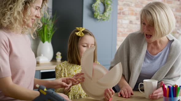Handheld video of granddaughter shows grandma a handmade easter bunny.  alt