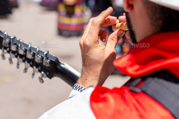 Close-up of a man playing a bamboo flute outdoors. Colombian folk music.