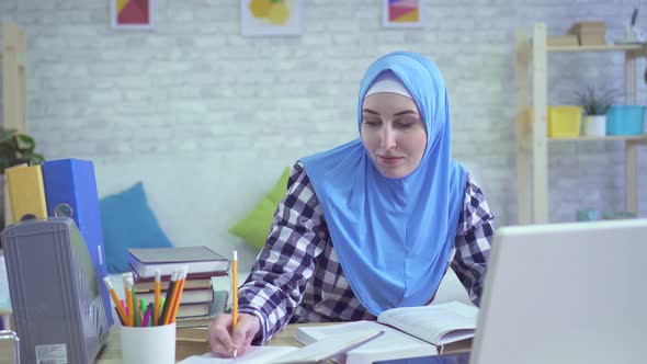 Beautiful Young Muslim Woman in Hijab Studying in Modern Apartments Portrait alt