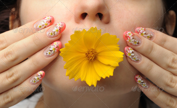Female face close and nail art