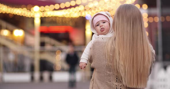 Loving Mother with a Baby in Spring Park