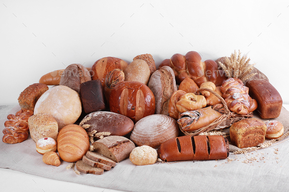 Different Types Of Baked Goods On Linen And White Wall Background Stock ...