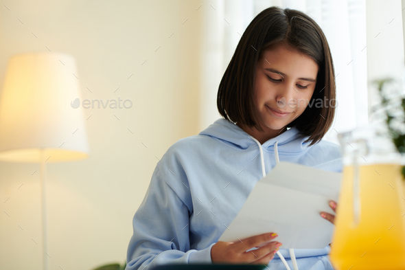 Teenage Girl Reading Letter from College