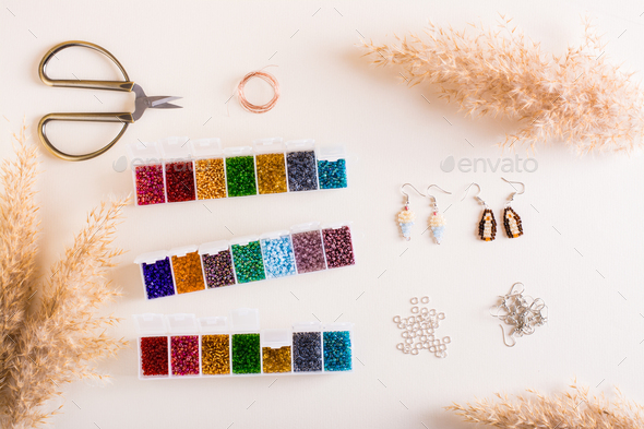 Containers with colored beads and accessories for beading. Needlework and handmade. Top view