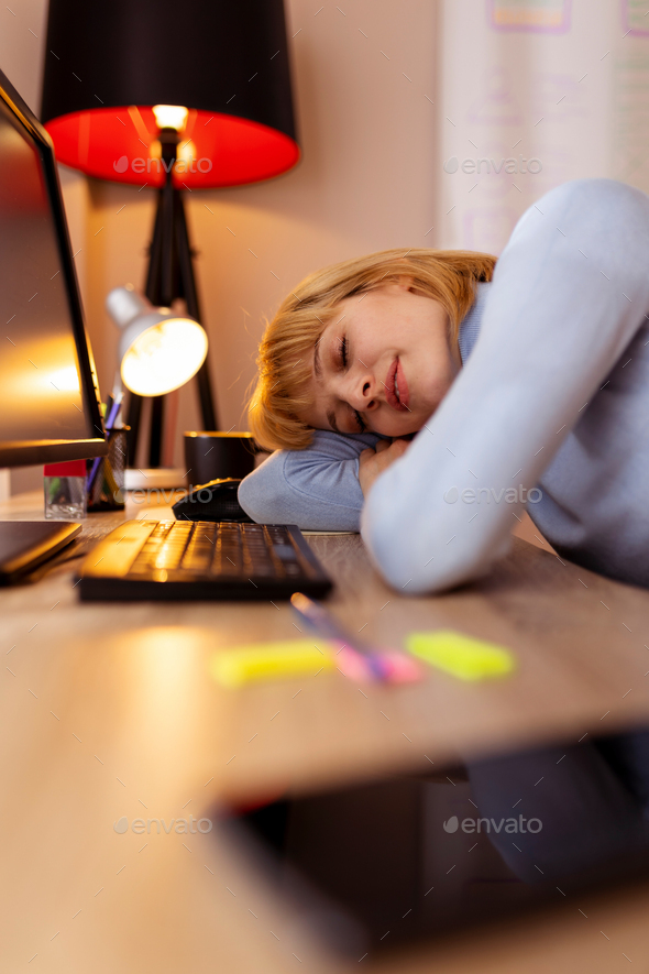 Woman taking a power nap while working in an office