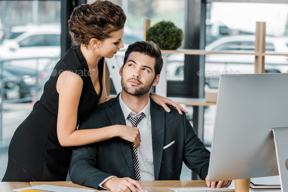 young seductive businesswoman flirting with colleague during work in ...