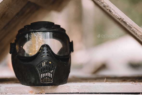 close up view of goggle mask covered by paintball splash outdoors Stock