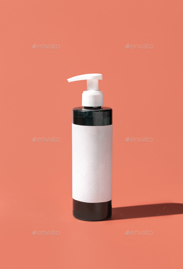 Cosmetic One pump Plastic bottle with blank label on pink, hard shadows. Mockup