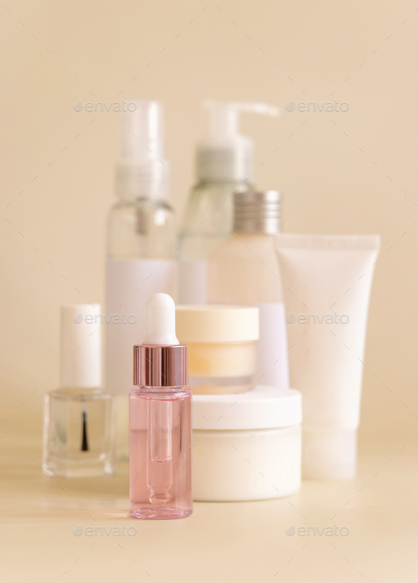 Natural cosmetic jarsand bottles and skin care accesories on light yellow close up