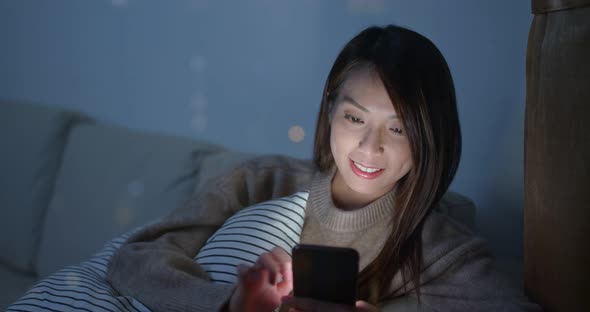 Woman use of mobile phone at home alt