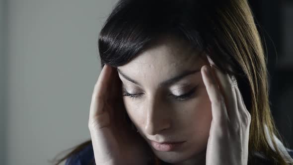 Exhausted woman having an headache