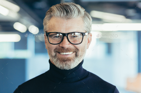 Close-up photo portrait of successful and happy senior gray-haired businessman, male investor